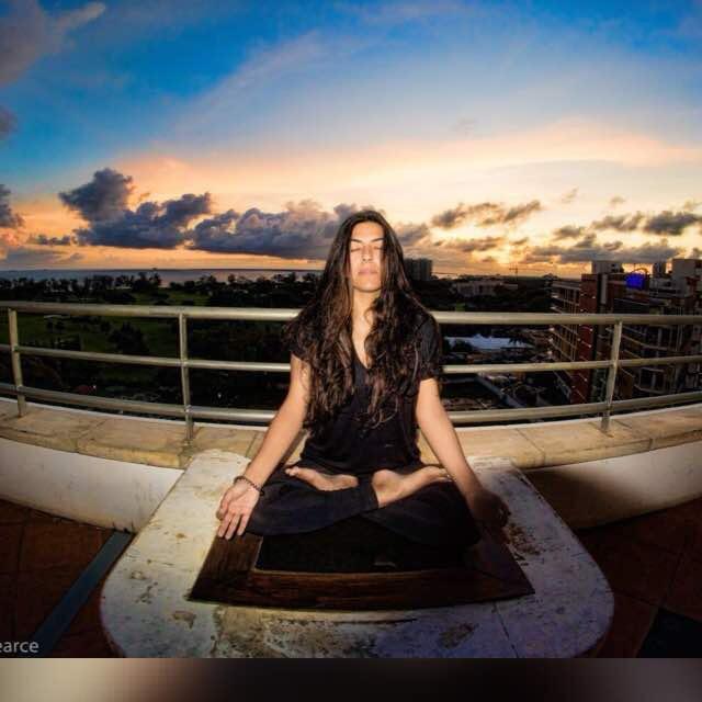 Ayesha Samji meditating at sunset — Integrative Wellness Coach